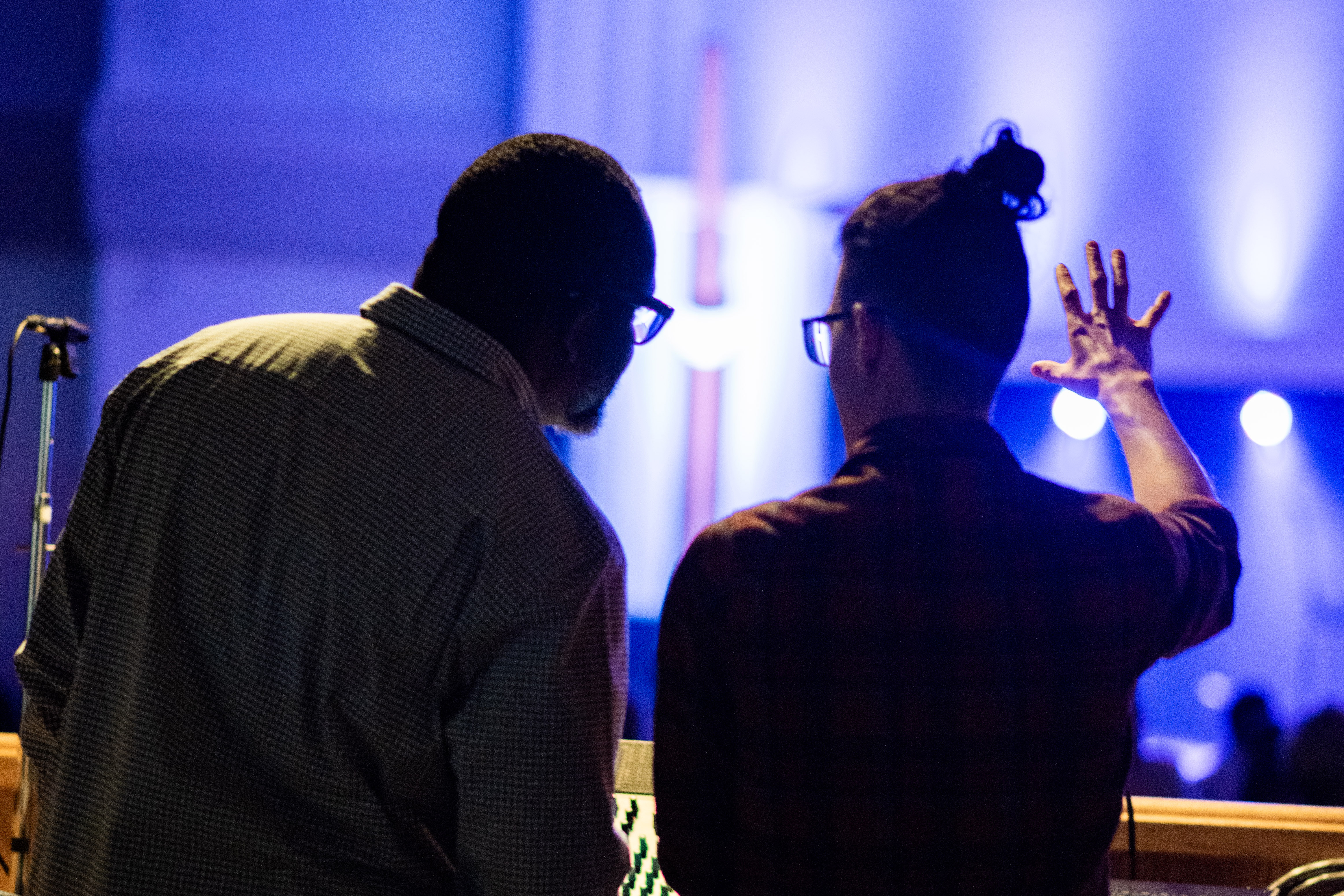Image of Brandon and a volunteer talking during a service